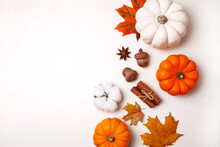 Small Decorative Pumpkins And Autumn Leaves On White Table. Flat Lay Style
