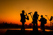 © Krisda - Silhouette twilight scene of trio musician background.