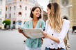 © NDABCREATIVITY - Happy travel together of two beautiful women in city centre.