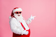 © deagreez - Profile side photo overweight santa claus touch his big abdomen point index finger copyspace x-mas ads wear sunglass sunspenders overall headwear isolated pastel color background