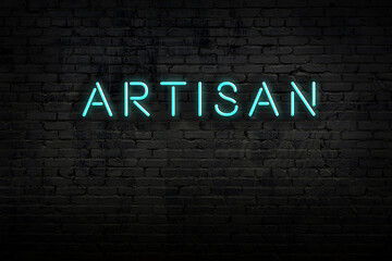 Wall Mural - Neon sign. Word artisan against brick wall. Night view