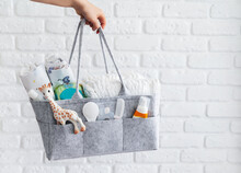 Mothers Bag With Toy, Diapers And Accessories On White Background.