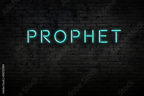 Fotografía Night view of neon sign on brick wall with inscription prophet