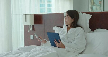 Poster - Woman use of tablet computer and control the curtain by remote at hotel room