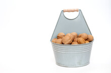 Walnuts In A Bucket On A White Background