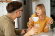 © JustLife - Young couple making delicious food at home. Loving couple enjoying in the kitchen..