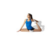© master1305 - Split. Beautiful young female athlete stretching, training on white studio background, portrait with shadows. Sportive fit model in motion and action. Flexibility, healthy lifestyle, style concept.