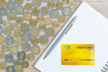 Top view coins with credit card on wood table