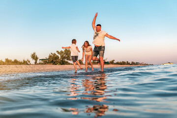 Wall Mural - young funny family at vacation