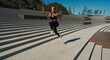 © Alexandr - A young woman athlete runs on concrete steps. A blonde in a black suit is engaged at dawn. Healthy lifestyle. Motivation