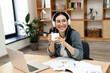 © Drobot Dean - Photo of asian woman drinking coffee working with laptop and papers