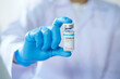 © Pormezz - close up hands of doctor holding vaccine of covid-19 disease or corona virus.