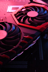 Poster - Computer game graphics card, videocard with two coolers on circuit board ,motherboard background. Close-up. With red-blue lighting