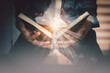 © vii - The light coming from the book in the hand of man concept wisdom religion reading imagination.