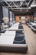 © mad_production - Vertical shot of a row of orthopedic beds on sale at furniture store