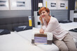 © mad_production - Charming woman smiling to the camera while choosing new orthopedic bed to buy at home goods store