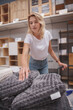 © mad_production - Selective focus on soft cushions mature housewife is buying at furnishings store