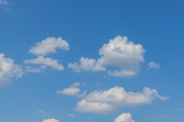 Blue sky on which are white clouds.