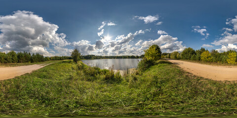 Wall Mural - seamless spherical hdri panorama 360 degrees angle view on grass coast of small lake or river in sunny summer day and windy weather with beautiful clouds in equirectangular projection, VR content