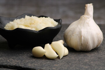 Garlic Paste or Toum or Toumya with raw garlic, isolated over black background