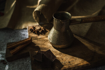 Wall Mural - coffee, chocolate, cinnamon and spices on a brown wooden board