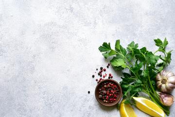 Wall Mural - Culinary background with assortment of spices : lemon, garlic, pepper,parsley. Top view with copy space.