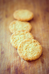 Vertical closeup shot of crunchy cookies with sesame seeds on a wooden board