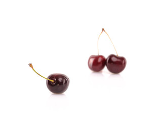 Fresh cherries on white reflective background. Isolated