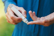 © zakalinka - young woman hands using lancet on finger to check blood sugar level, diabetes concept, health care