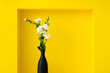 © MaaHoo Studio/Stocksy - Flowers in a vase in a yellow background