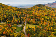 New Hampshire Farm House On Rural Road In Fall Foliage