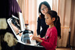 © MaaHoo Studio/Stocksy - mother teaching daughter to play piano
