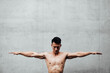 © MaaHoo Studio/Stocksy - Portrait bare chested man with arms outstretched