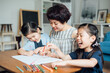 © MaaHoo Studio/Stocksy - Mother and her two daughters painting at home