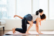 © MaaHoo Studio/Stocksy - Asian young mom and daughter practicing yoga at home