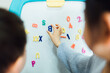 © MaaHoo Studio/Stocksy - Cute toddler girl and boy learning before white board at home