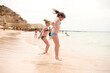 © CHRISTINA K/Stocksy - Sisters jumping in the sea