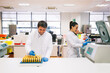 © Inuk Studio/Stocksy - Smiling man and woman in lab coats analyzing blood samples together while working in innovative laboratory.