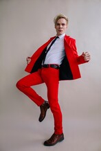 Classy Male In Bright Red Suit In Studio