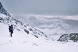 © Liam Grant Photography/Stocksy - Winter mountaineer using Ice Axe and crampons below Great End. Esk Hause, Cumbria, UK.