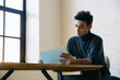 © Inuk Studio/Stocksy - Man using tablet at desk