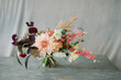 © Adrian Cotiga/Stocksy - Flower bouquet against grey cloth background with copy space