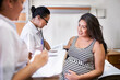 © Per Swantesson/Stocksy - Happy pregnant woman visiting a hospital for a checkup