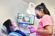© Per Swantesson/Stocksy - Dentist preparing for a tooth whitening procedure with a female client