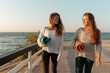 © Milles Studio/Stocksy - Adult relaxed women going along waterfront to place yoga training during sunrise