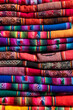 © Bisual Studio/Stocksy - Pile of Colorful indigenous fabrics