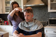 © Ronnie Comeau/Stocksy - Home Haircut, Wife Cutting Husband's Hair