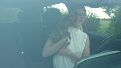 Wall Mural - Beautiful woman with cute dog sitting in modern car