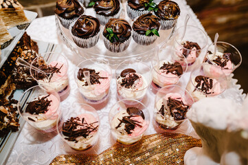 Wall Mural - Dessert jelly in glass. Delicious Italian dessert Panna Cotta with jelly. Festive sweet table with baking. Top view.