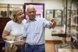 © JackF - Male and female pensioners visiting exposition of museum and reading guidebook